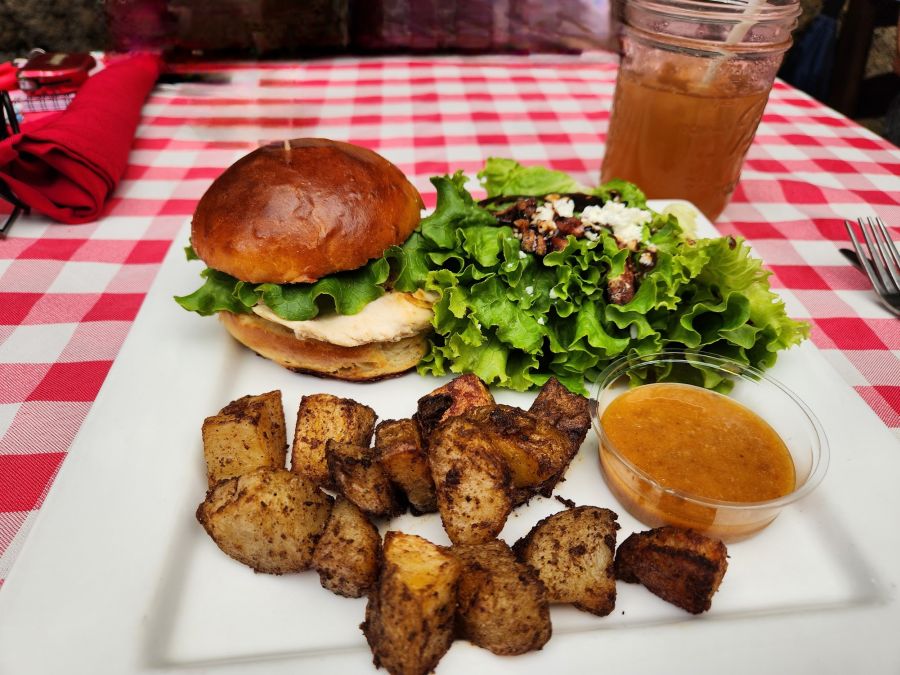 Vanilla bourbon marinated chicken breast on a vanilla sweet bread bun, topped with caramelized onions and served with a vanilla mango chutney aioli. Photo by Karen Alman